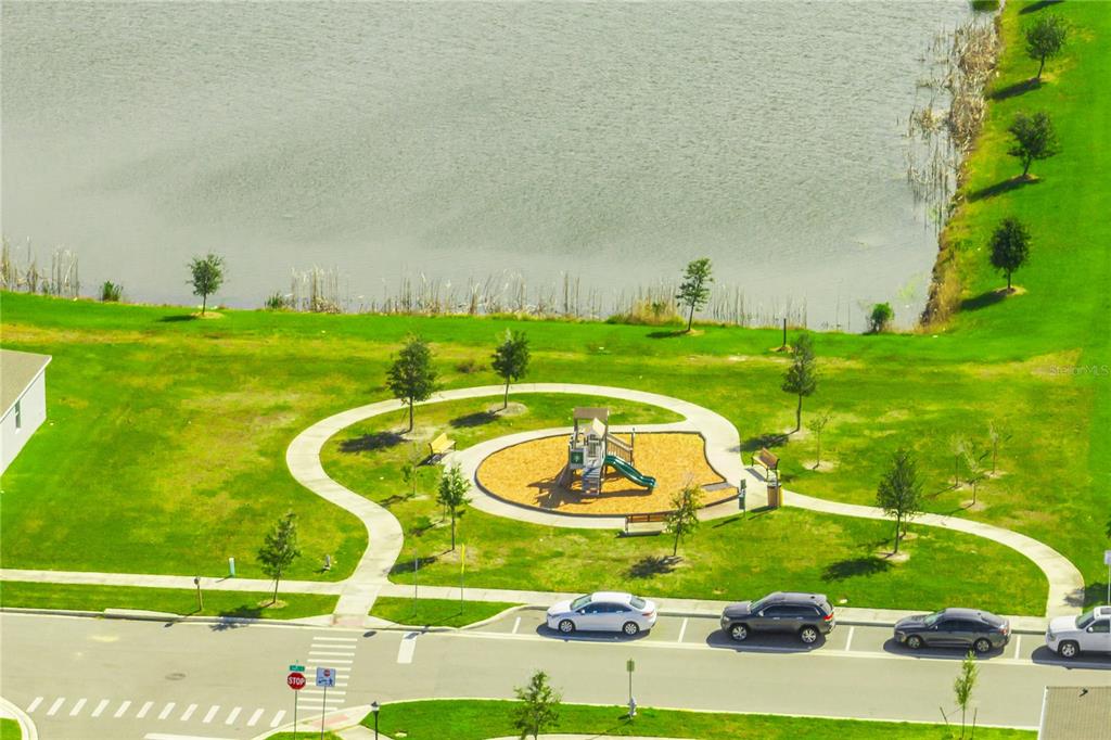 1359 Isleta Loop Kissimmee, FL 34741 - Photo 57 of 57 a view of a swimming pool with a garden and trees