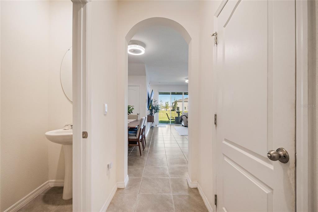 1359 Isleta Loop Kissimmee, FL 34741 - Photo 7 of 57 a view of a hallway with a dining table and chairs