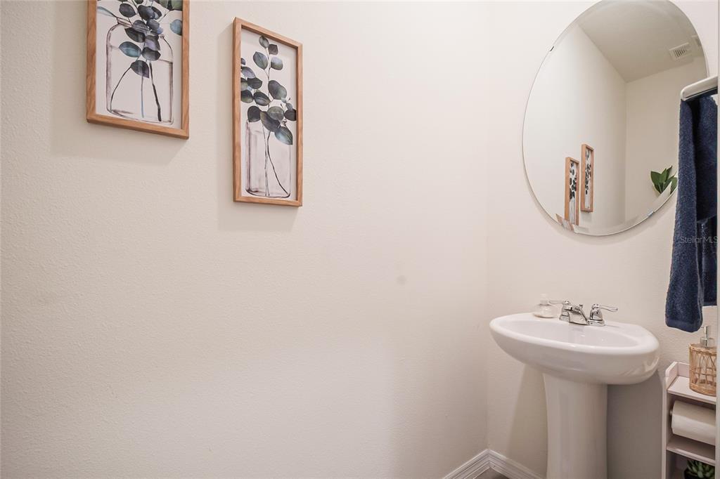 1359 Isleta Loop Kissimmee, FL 34741 - Photo 8 of 57 a bathroom with a sink and mirror