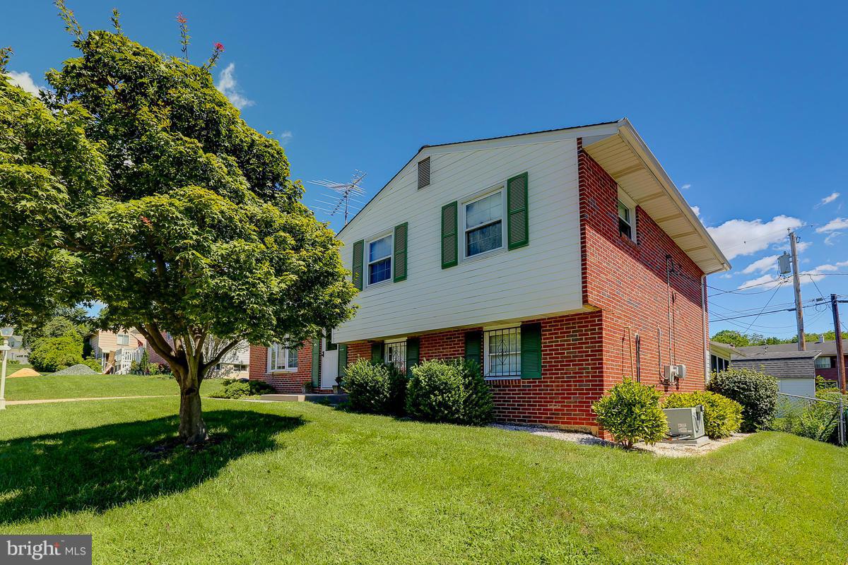9007 Fieldchat Road Baltimore, MD 21236 - Photo 1 of 30 a front view of a house with a yard