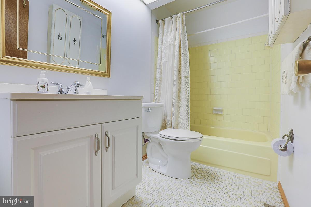 9007 Fieldchat Road Baltimore, MD 21236 - Photo 19 of 30 a bathroom with a sink mirror vanity and toilet