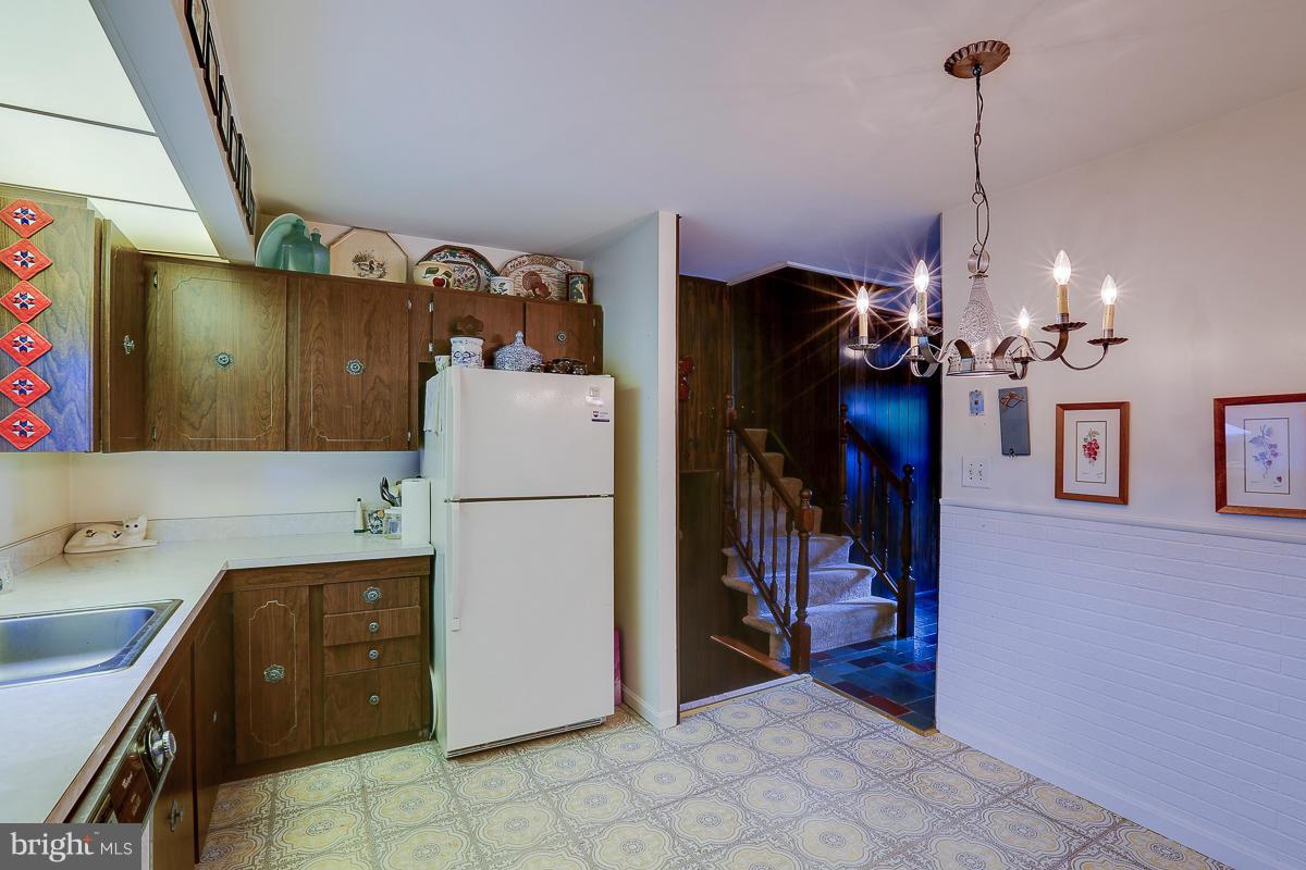9007 Fieldchat Road Baltimore, MD 21236 - Photo 4 of 30 a kitchen with a refrigerator a sink and cabinets