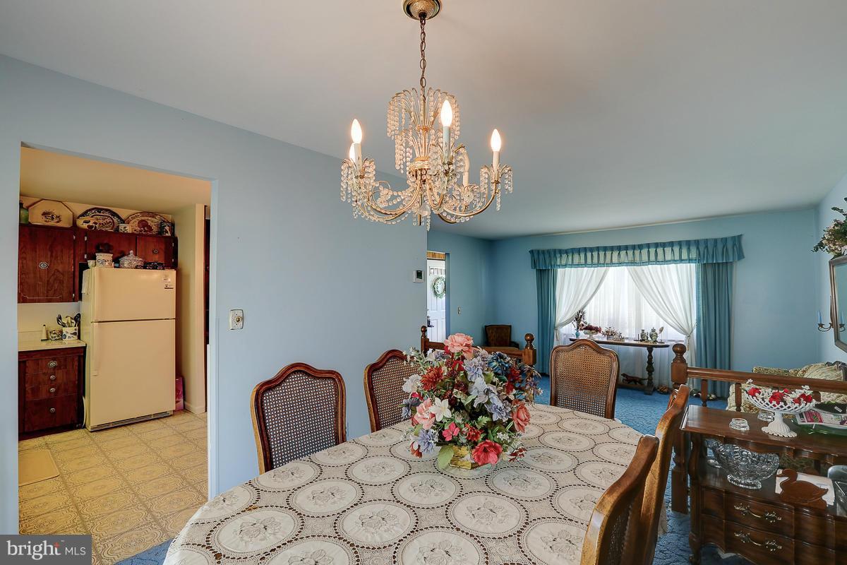 9007 Fieldchat Road Baltimore, MD 21236 - Photo 7 of 30 a view of a dining room with furniture and chandelier
