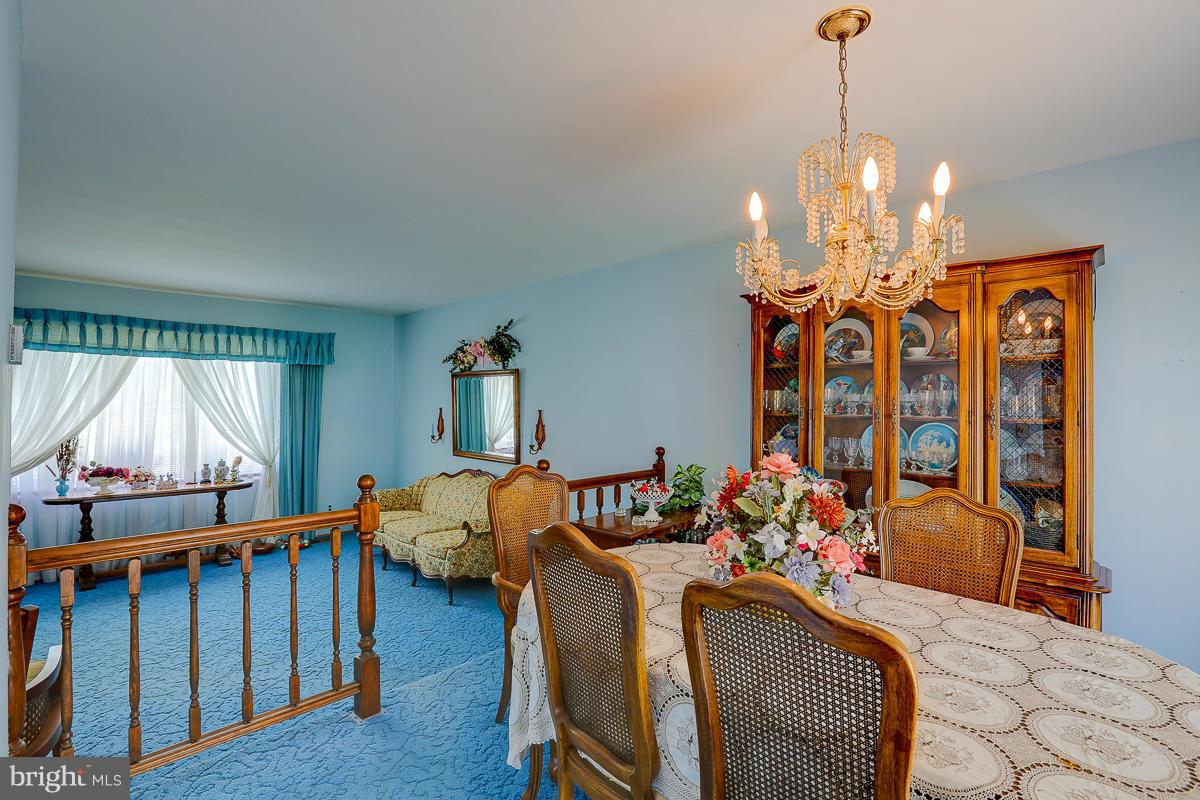 9007 Fieldchat Road Baltimore, MD 21236 - Photo 8 of 30 a bedroom with furniture and a chandelier