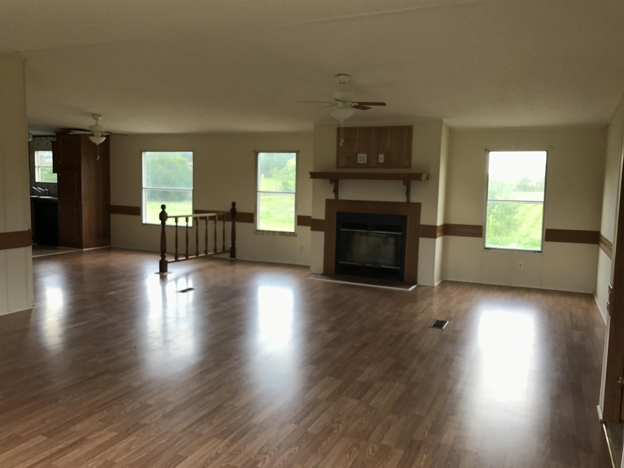 6029 McDaniels Road Springfield, TN 37172 - Photo 2 of 14 a view of a livingroom with furniture a fireplace and wooden floor