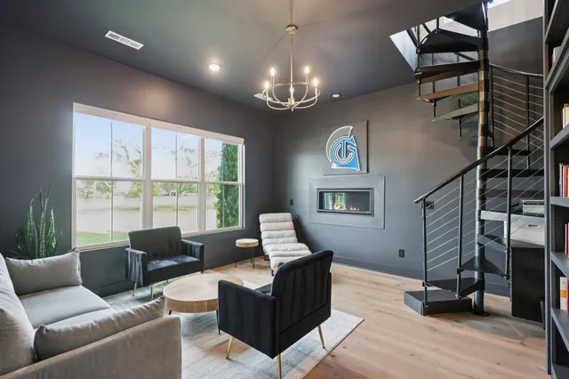 a dining room with furniture a chandelier and wooden floor