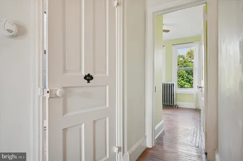 a view of a hallway with wooden floor