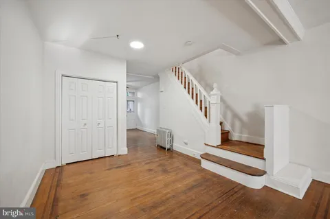 a view of entryway and hall with wooden floor