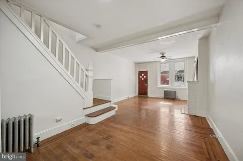 a view of entryway and hall with wooden floor