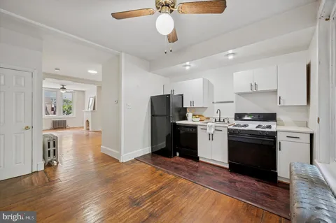 a kitchen with a stove a refrigerator and a sink