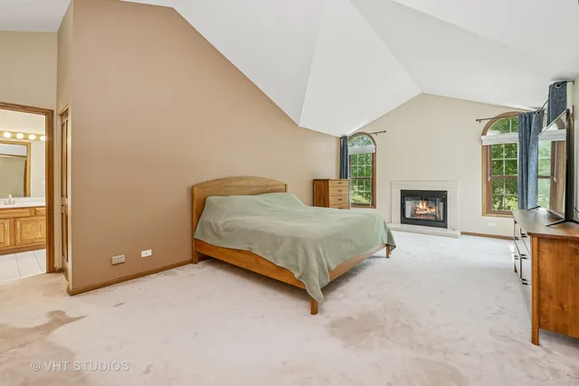a spacious bedroom with a bed and a fireplace