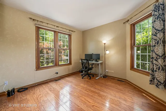 a view of a workspace with furniture and a window