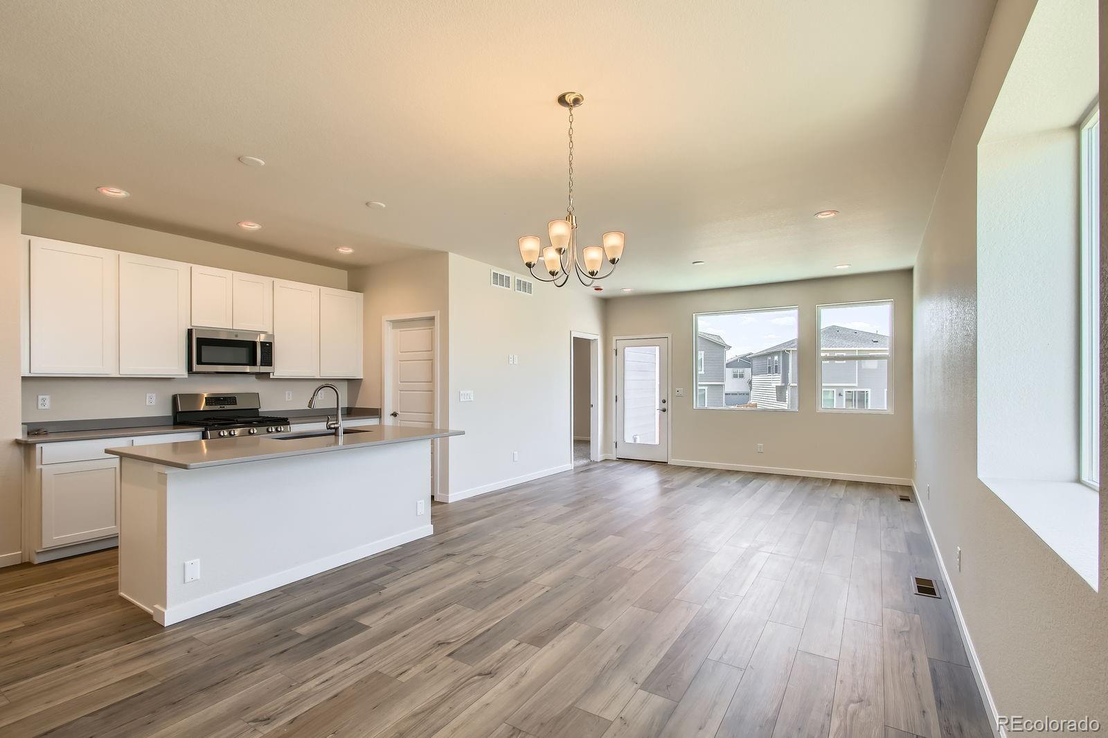 9085 Rifle Street Commerce City, CO 80022 - Photo 13 of 31 a view of a kitchen with stove top oven and cabinets