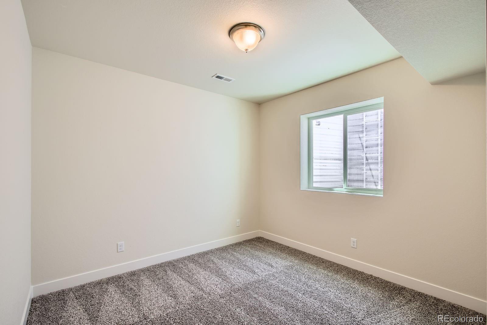9085 Rifle Street Commerce City, CO 80022 - Photo 22 of 31 an empty room with a window
