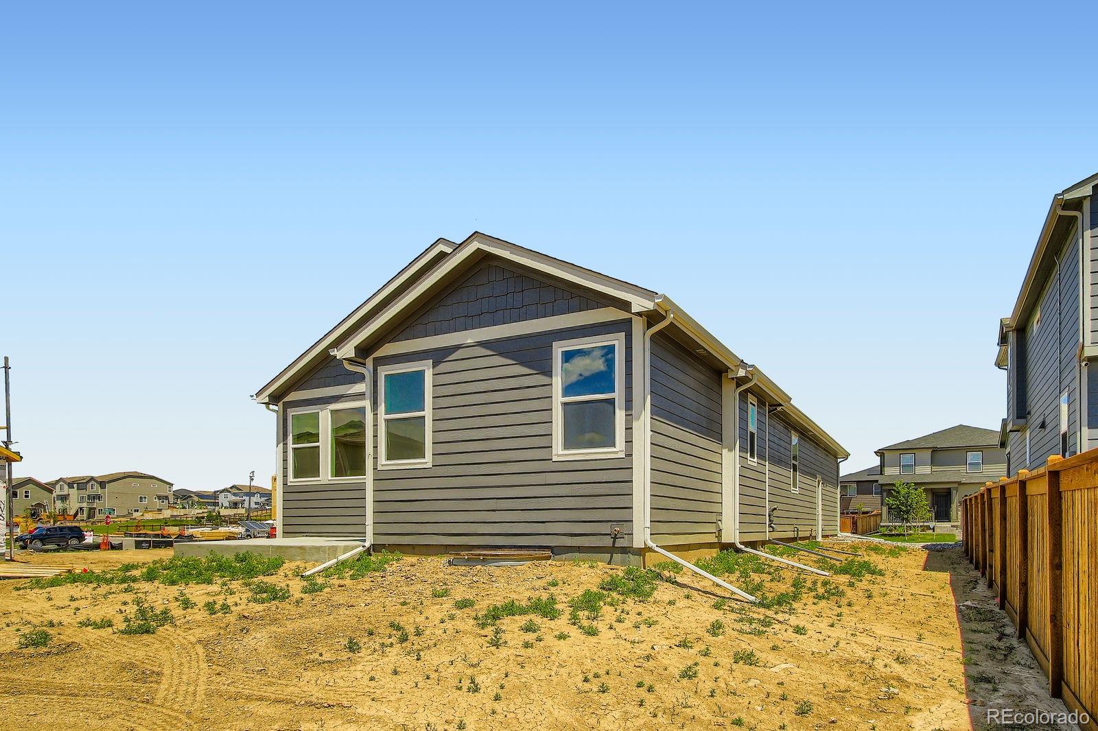 9085 Rifle Street Commerce City, CO 80022 - Photo 29 of 31 a view of a house with a yard