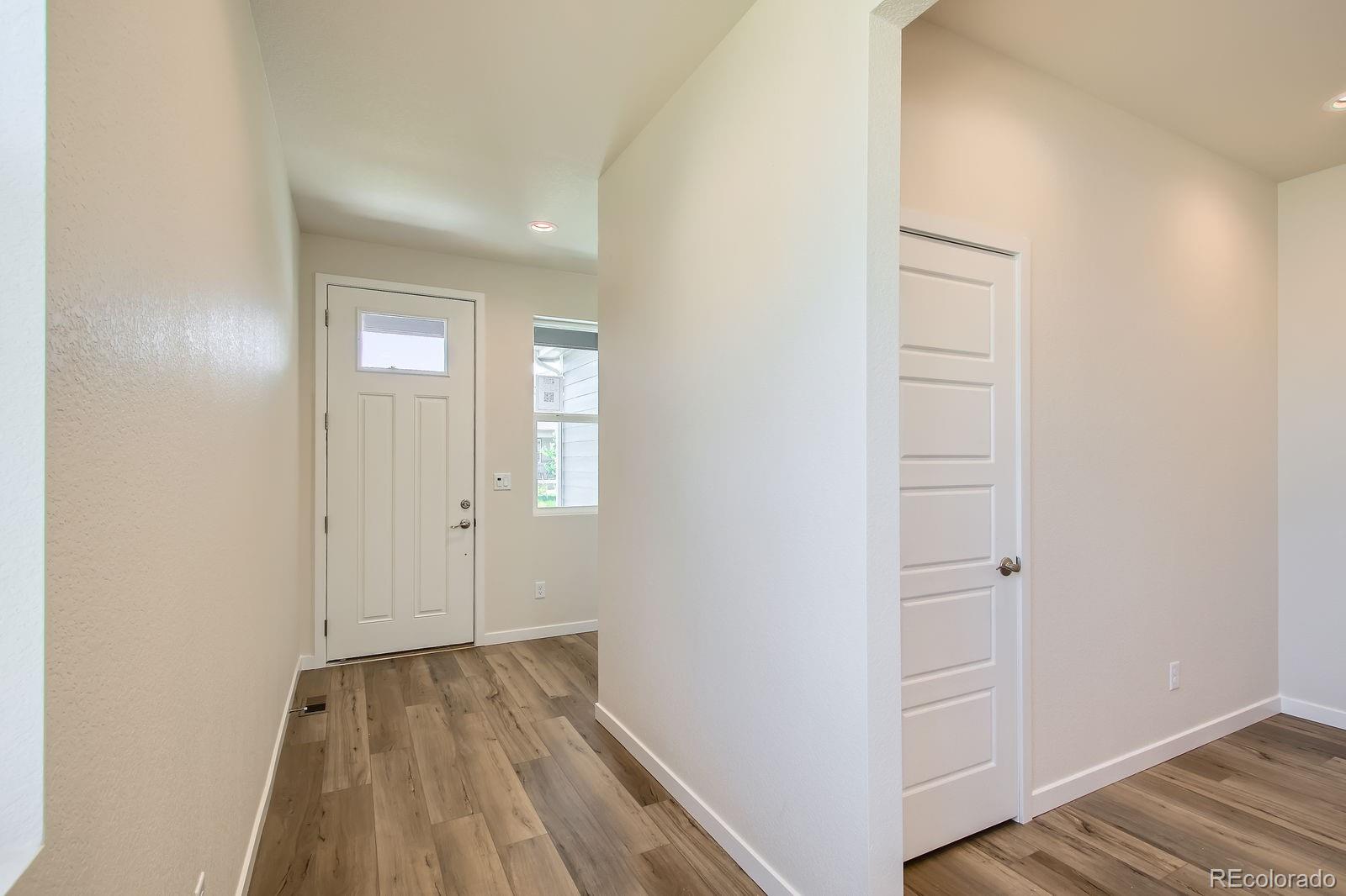 9085 Rifle Street Commerce City, CO 80022 - Photo 5 of 31 a view of a room with wooden floor