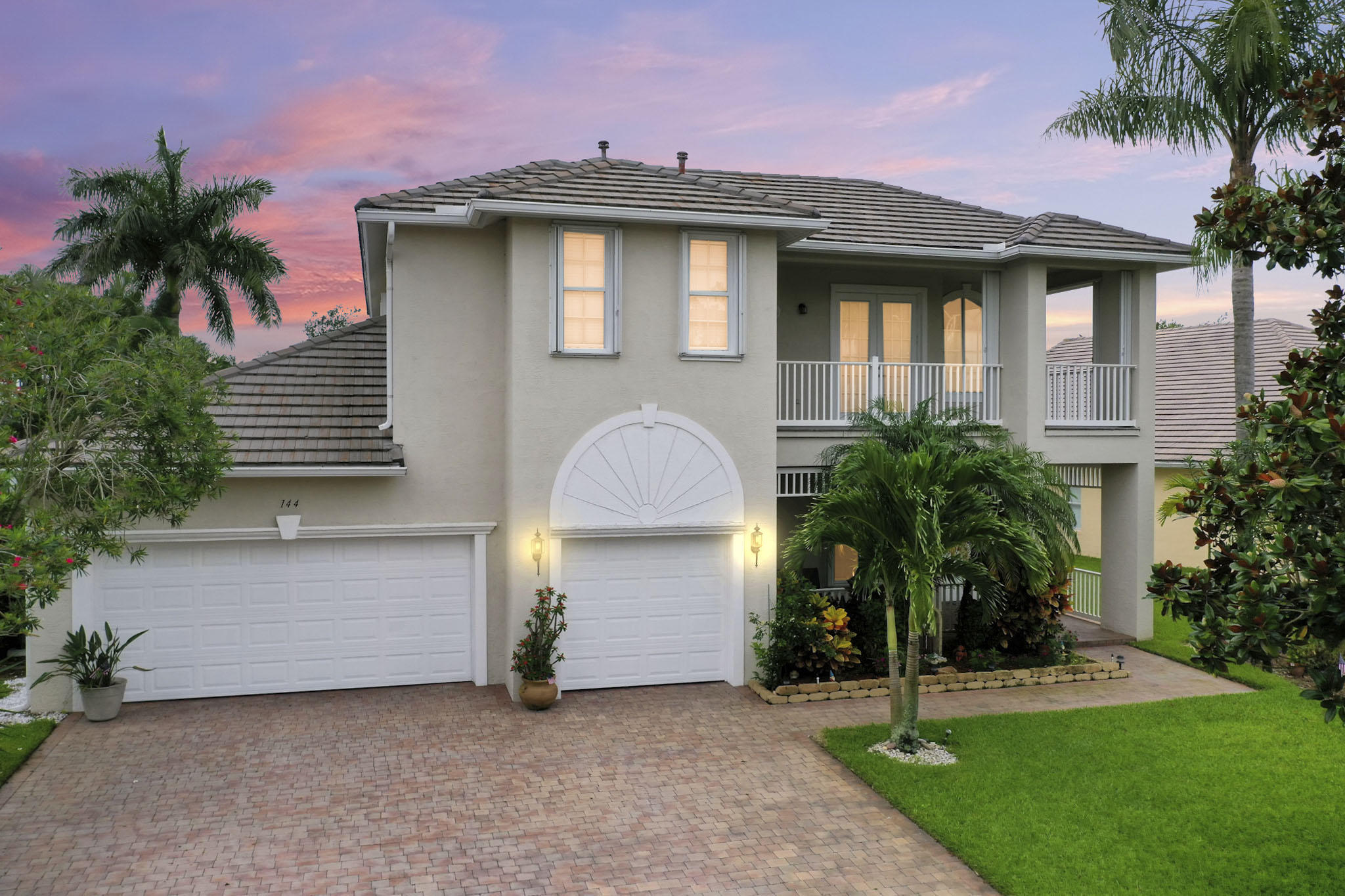 144 Northwest Magnolia Lakes Boulevard Port St. Lucie, FL 34986 - Photo 1 of 62 a front view of a house with a yard and garage