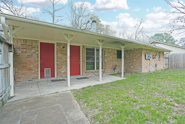 a front view of house with a garden