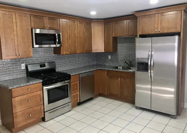 a kitchen with a sink stove and refrigerator