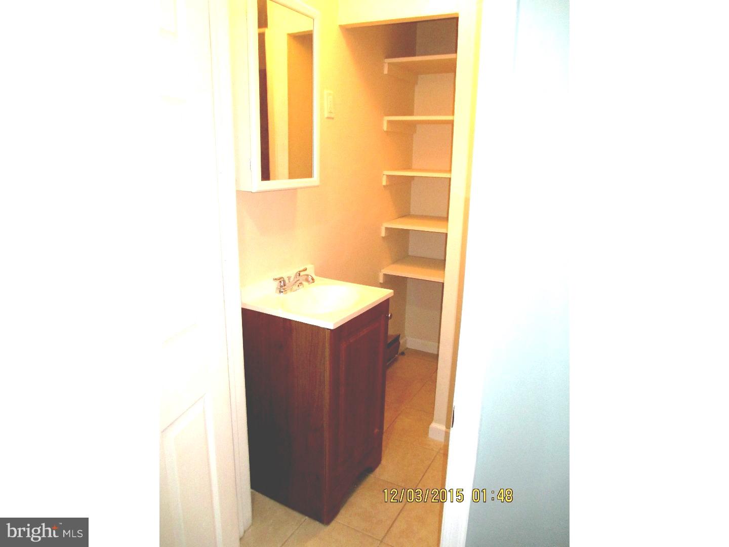 2124 South 15th Street Philadelphia, PA 19145 - Photo 14 of 14 a bathroom with a sink and a mirror