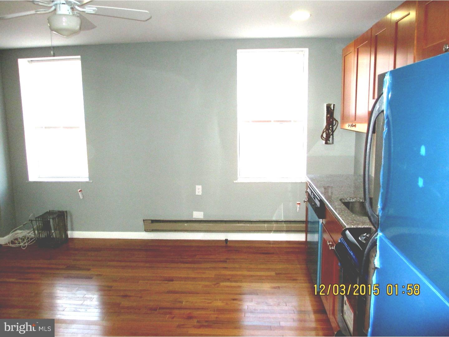 2124 South 15th Street Philadelphia, PA 19145 - Photo 2 of 14 a view of an empty room with wooden floor and a window