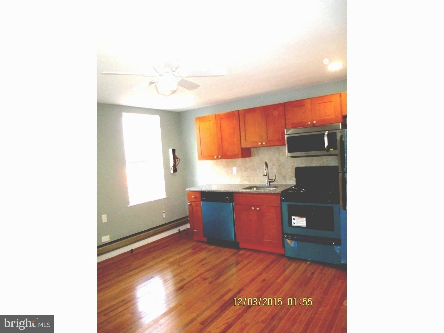 2124 South 15th Street Philadelphia, PA 19145 - Photo 3 of 14 a kitchen with granite countertop a refrigerator and a sink