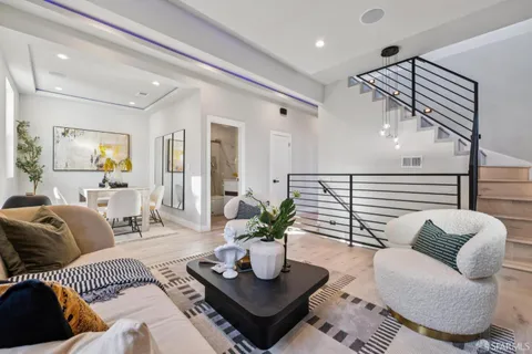 a bedroom with two beds and potted plant