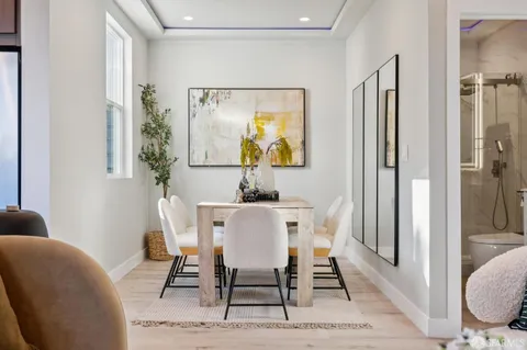 a bedroom with furniture and a large window