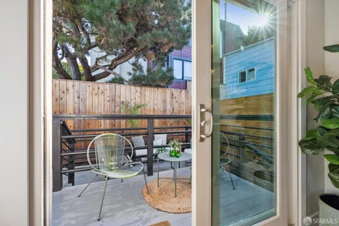 a table with a couch and a vase with flowers on it