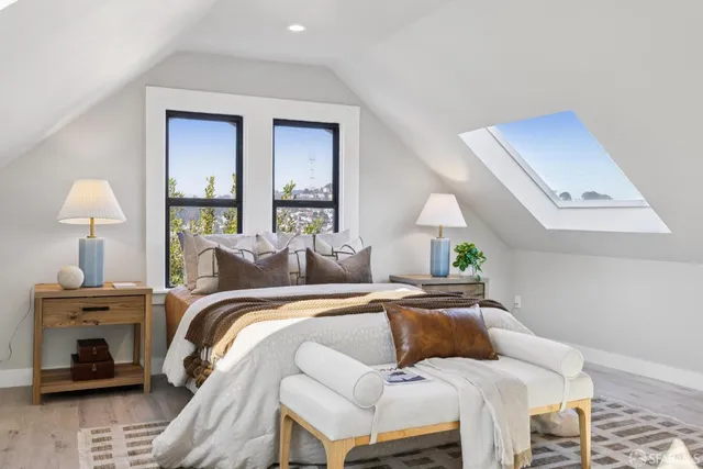 a view of a balcony with wooden floor and iron fence