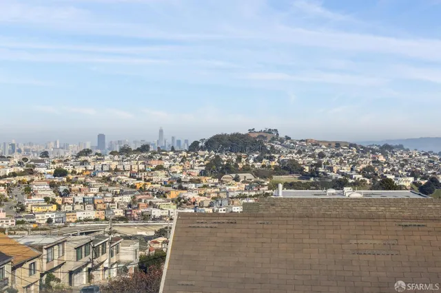a view of house with deck and outdoor seating