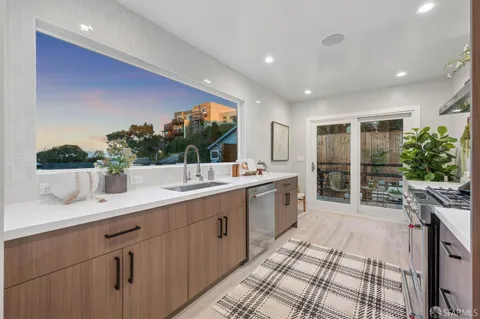 a living room with furniture flowerpot and wooden floor
