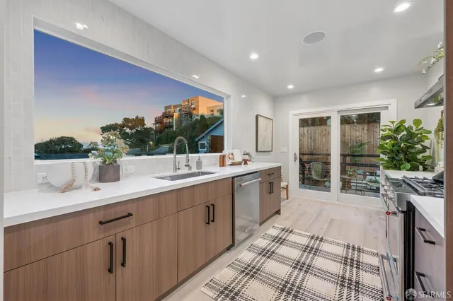 a living room with furniture flowerpot and wooden floor