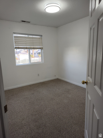 1735 West 540 North, Unit 1402 St. George, UT 84770 - Photo 10 of 14 Carpeted spare room with baseboards