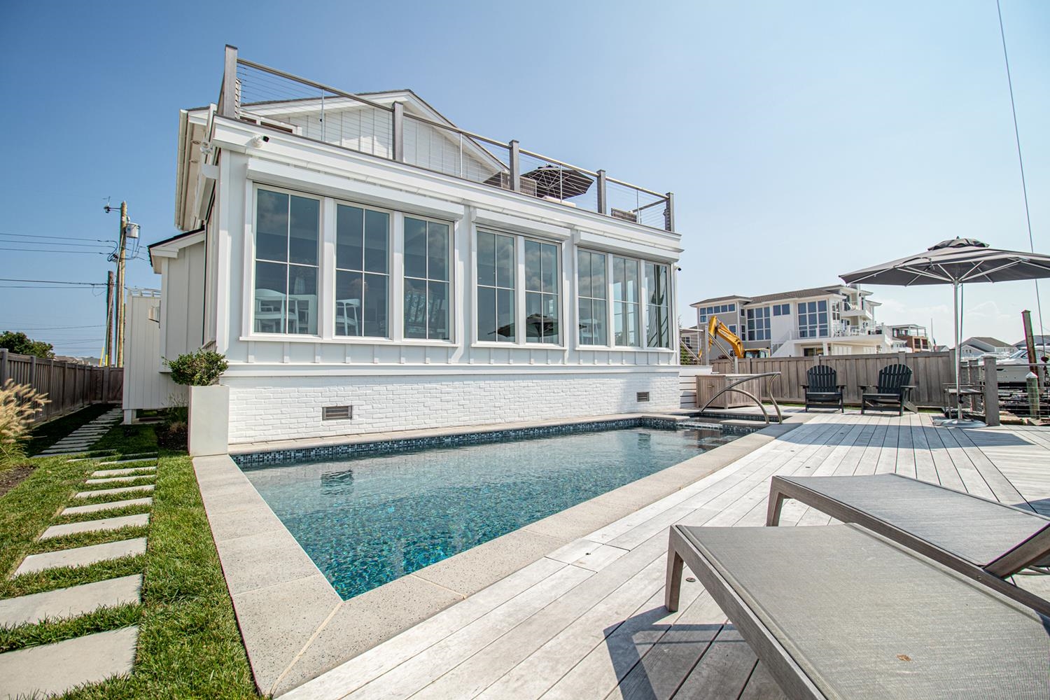 7708 Sunset Drive Avalon, NJ 08202 - Photo 16 of 37 a front view of a house with swimming pool