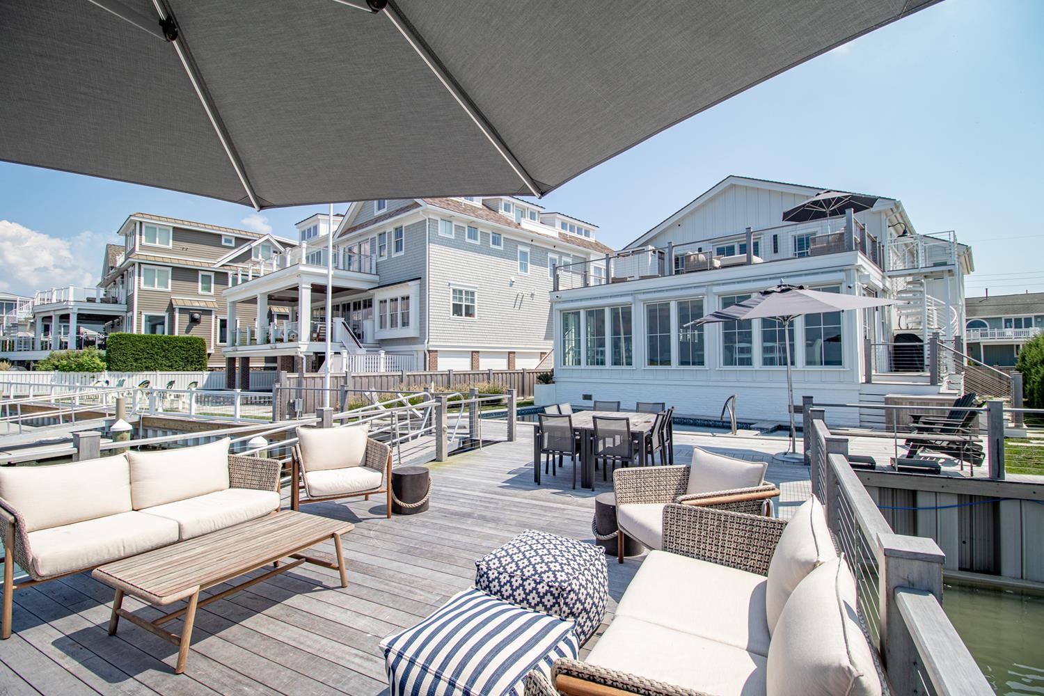 7708 Sunset Drive Avalon, NJ 08202 - Photo 18 of 37 a view of a patio with couches table and chairs with wooden floor