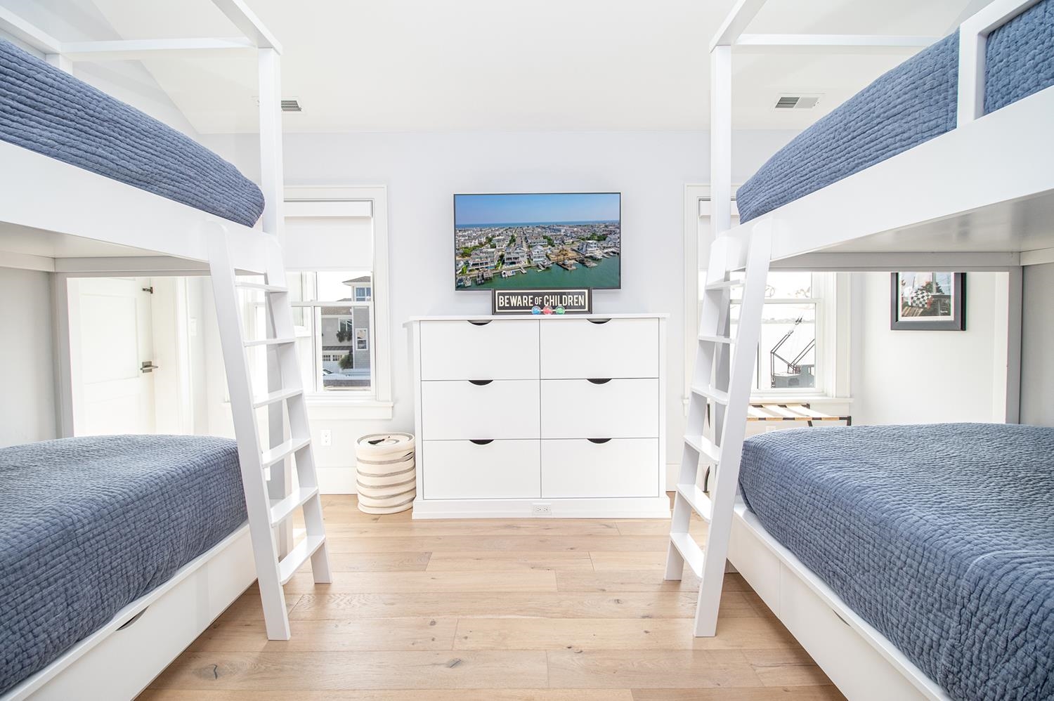 7708 Sunset Drive Avalon, NJ 08202 - Photo 29 of 37 a bedroom with a bed and a flat screen tv