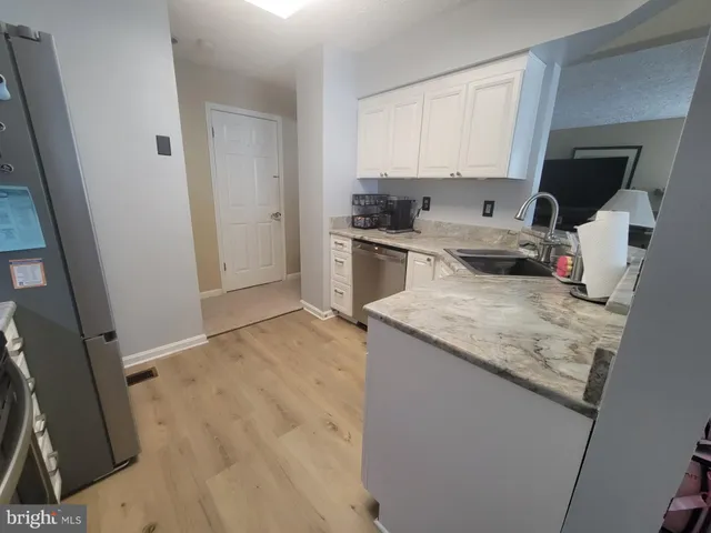 a kitchen with a sink stove and refrigerator