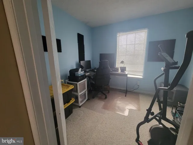 a view of a workspace with furniture and a flat screen tv