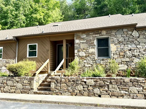 a front view of a house with trees