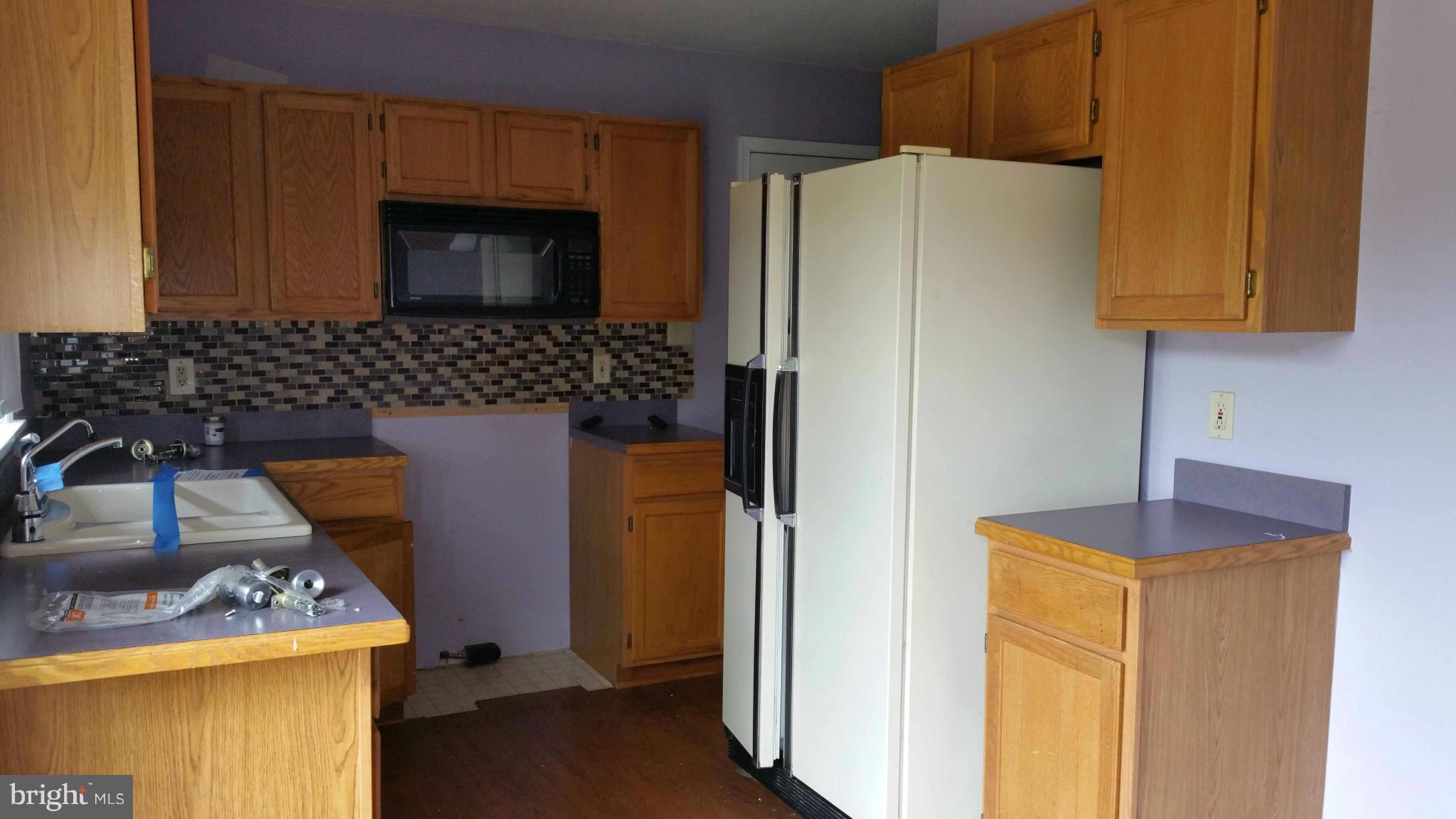 13727 Barnhart Road Clear Spring, MD 21722 - Photo 3 of 20 a kitchen with a refrigerator sink and stove top oven