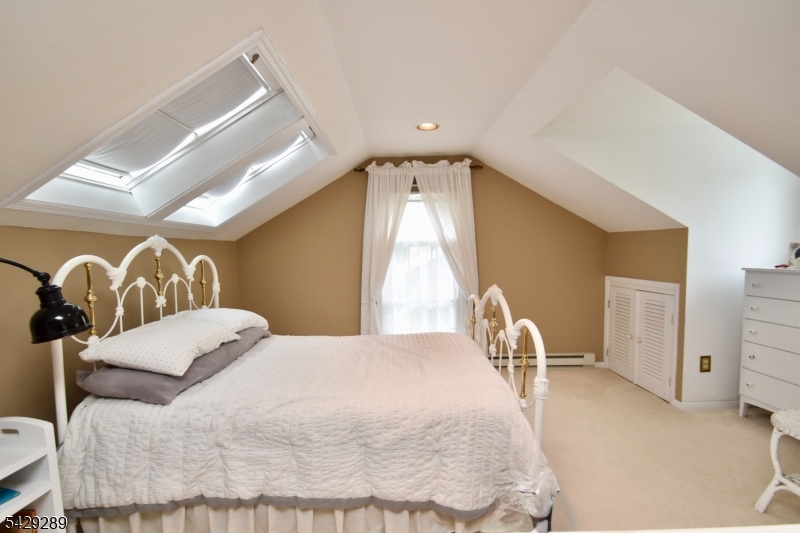 16 Pequot Trail Oak Ridge, NJ 07438 - Photo 10 of 18 a bedroom with a bed and a large mirror