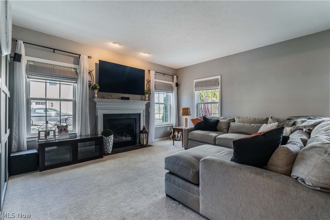 6687 List Street Northwest Canton, OH 44708 - Photo 4 of 21 Carpeted living area featuring a fireplace with flush hearth