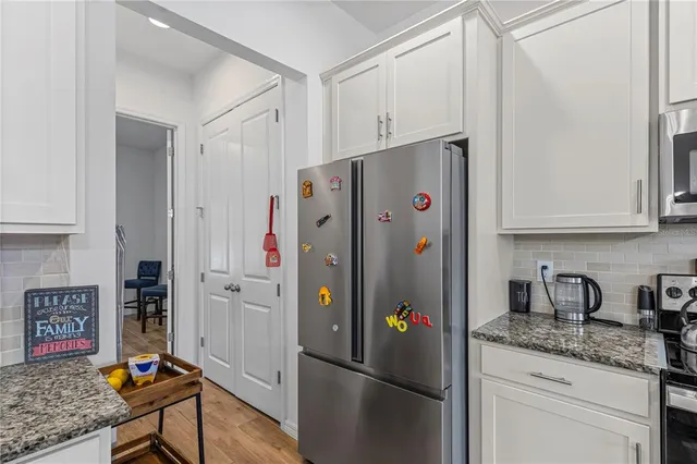 a white refrigerator freezer sitting in a kitchen