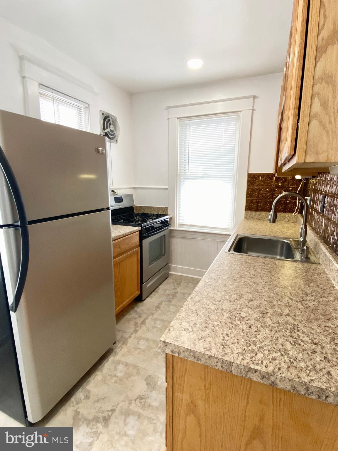 6 Goeller Avenue Baltimore, MD 21221 - Photo 20 of 43 Galley Kitchen new window being installed