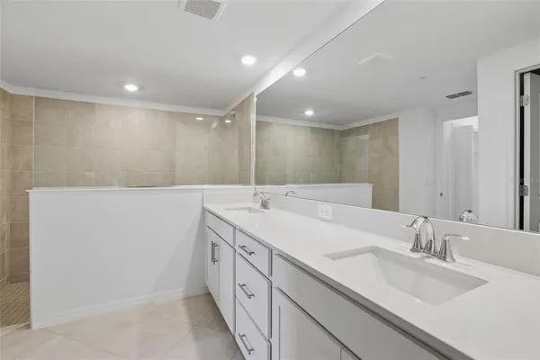 a bathroom with a double vanity sink and a mirror