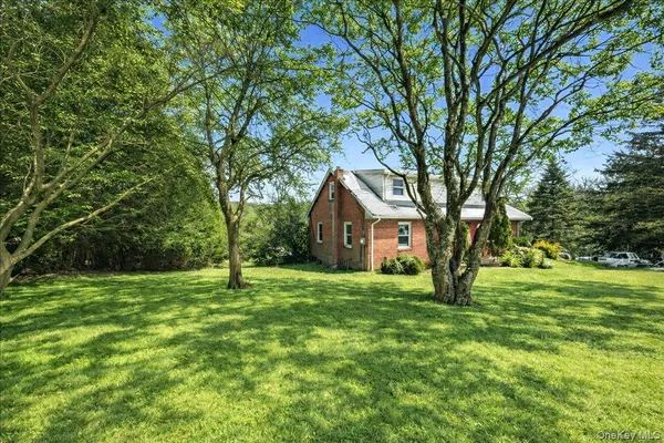 a house is sitting in middle od the grass