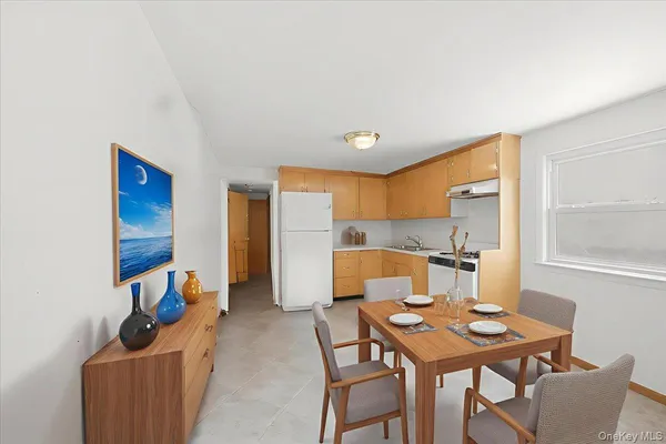 a dining room with furniture and window