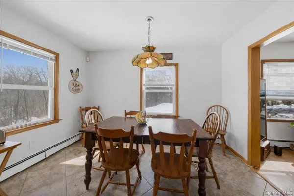a dining room with furniture and window