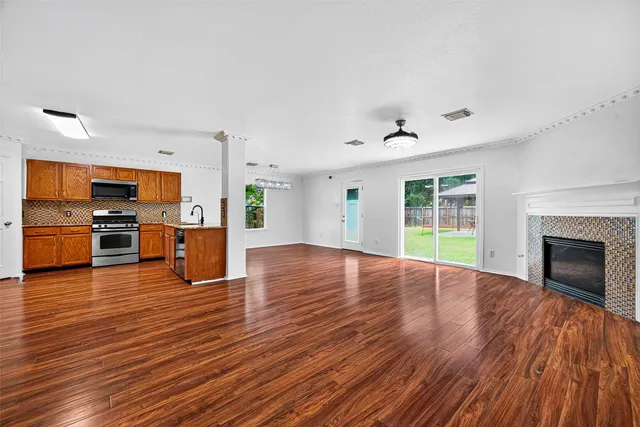 a view of kitchen with microwave and wooden floor